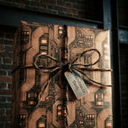 Copper and black circuit board wrapping paper with a twine bow on a gift box by Wrapped Studios.