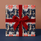 Dachshund Christmas wrapping paper with a red velvet bow on a holiday gift box by Wrapped Studios.