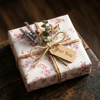 Pink floral wrapping paper with rustic twine, dried lavender, and a For You tag on a gift box by Wrapped Studios.