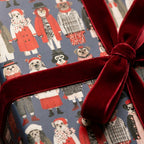 Cute dog Christmas wrapping paper tied with a luxury red velvet bow by Wrapped Studios.