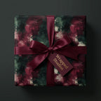 Luxury burgundy and green abstract Christmas gift wrap with a satin ribbon bow by Wrapped Studios.