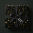 Elegant candlelit gift wrap, tied with a black ribbon. From Wrapped Studios.