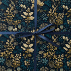 Elegant floral wrapping paper with a dark navy background and gold, teal botanical pattern, tied with a blue ribbon.