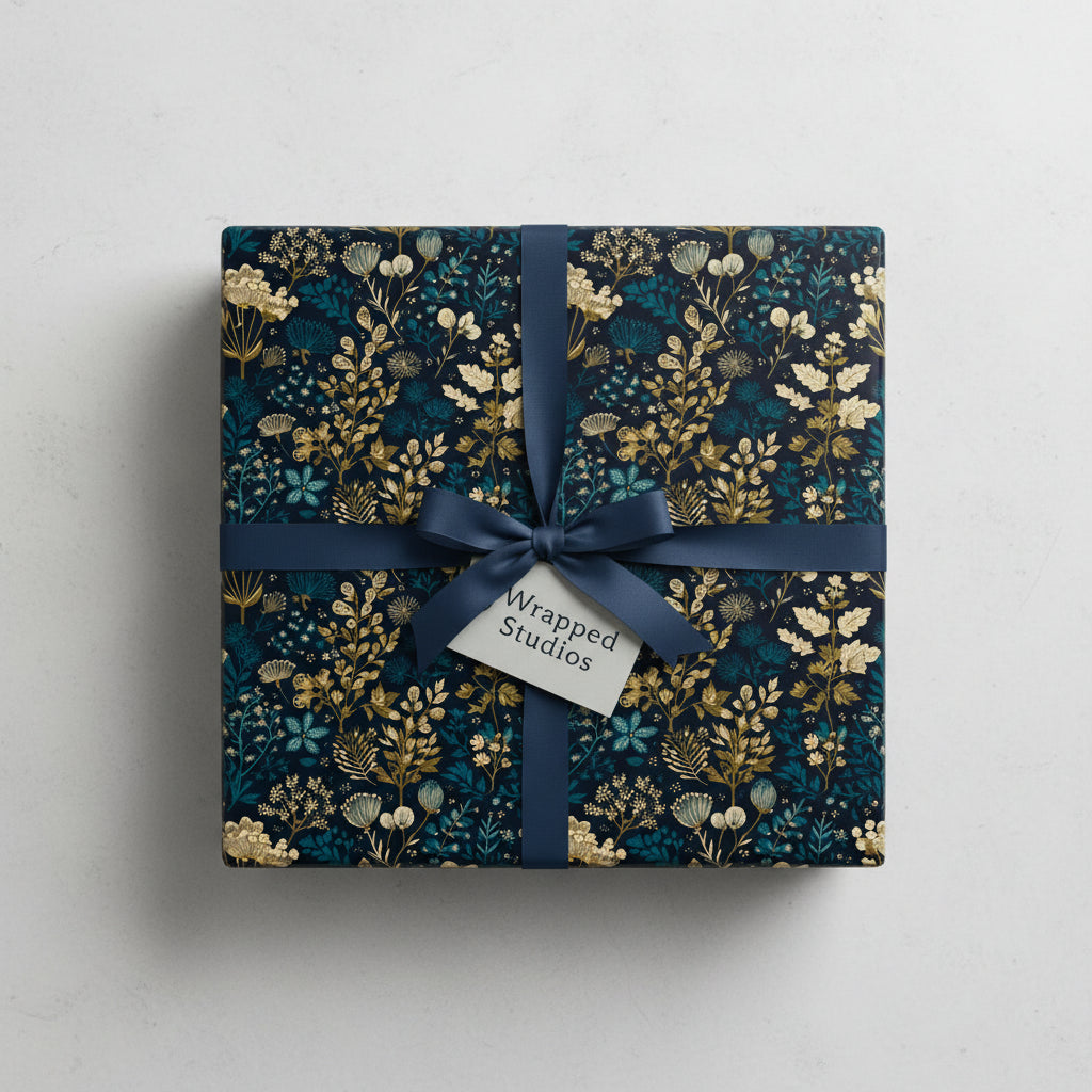 Navy and gold floral wrapping paper with satin ribbon, perfect for birthday or Christmas gifts.