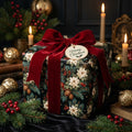 Vintage Christmas wrapping paper with white poinsettias and a red velvet bow, from Wrapped Studios.