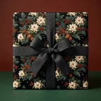 Luxury Christmas wrapping paper with botanical poinsettias and black bow. Holiday gift wrap by Wrapped Studios.