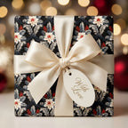Luxury floral Christmas wrapping paper on a gift box with cream satin ribbon and gift tag by Wrapped Studios.