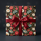 Luxury floral wrapping paper with dark vintage botanical print and red satin bow by Wrapped Studios.