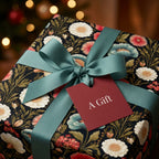 Luxury vintage floral wrapping paper with teal ribbon and red tag by Wrapped Studios.