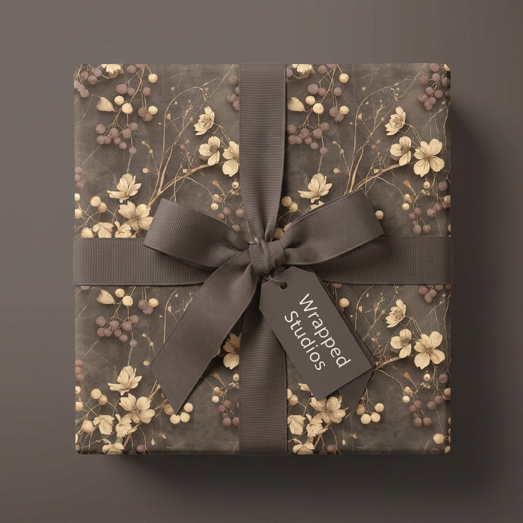 Vintage floral wrapping paper with cream botanical print and a brown ribbon, by Wrapped Studios.