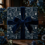 Luxury dark botanical wrapping paper with a navy velvet bow by Wrapped Studios.