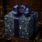 Luxury dark floral wrapping paper by Wrapped Studios on a gift box with a navy satin bow.