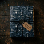Dark botanical wrapping paper with a gothic mushroom pattern on a gift box by Wrapped Studios.
