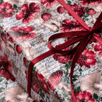 Vintage mushroom gift wrap by Wrapped Studios with cottagecore botanical pattern and a red satin bow.