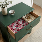 Cottagecore red floral wrapping paper lining a vintage green dresser drawer, by Wrapped Studios.