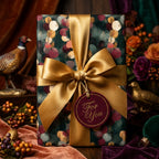 Elegant botanical wrapping paper in deep teal and gold with a luxury satin bow by Wrapped Studios.