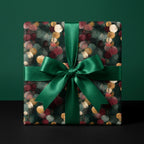 Luxury holiday wrapping paper with a green and gold botanical design and satin bow by Wrapped Studios.