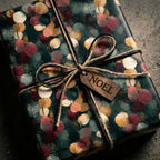 Luxury Christmas wrapping paper with gold and green abstract pattern and Noel gift tag by Wrapped Studios.