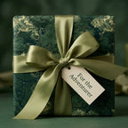 Luxury green forest wrapping paper with a sage ribbon and adventure gift tag by Wrapped Studios.