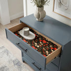 Red poppy floral wrapping paper used as a drawer liner in a blue dresser. By Wrapped Studios.