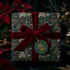 Vintage floral Christmas wrapping paper with a luxury red velvet bow on a gift box by Wrapped Studios.