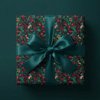 Luxury floral wrapping paper in dark botanical print with a teal satin bow by Wrapped Studios.