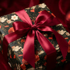 Luxury vintage floral wrapping paper with a red satin bow on a gift box by Wrapped Studios.