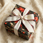 Luxury dark floral wrapping paper with red poppies and a cream bow by Wrapped Studios.