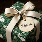 Vintage green floral wrapping paper with cream bow and Celebrate tag by Wrapped Studios.