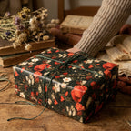 Vintage floral wrapping paper with red poppies on a rustic gift box with green twine, by Wrapped Studios.