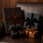 Elegant presents wrapped in striped and solid luxury gift wrap with velvet bows.