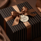 Elegant "With Love" gift wrapped in modern striped wrapping paper with a satin bronze ribbon and bow.