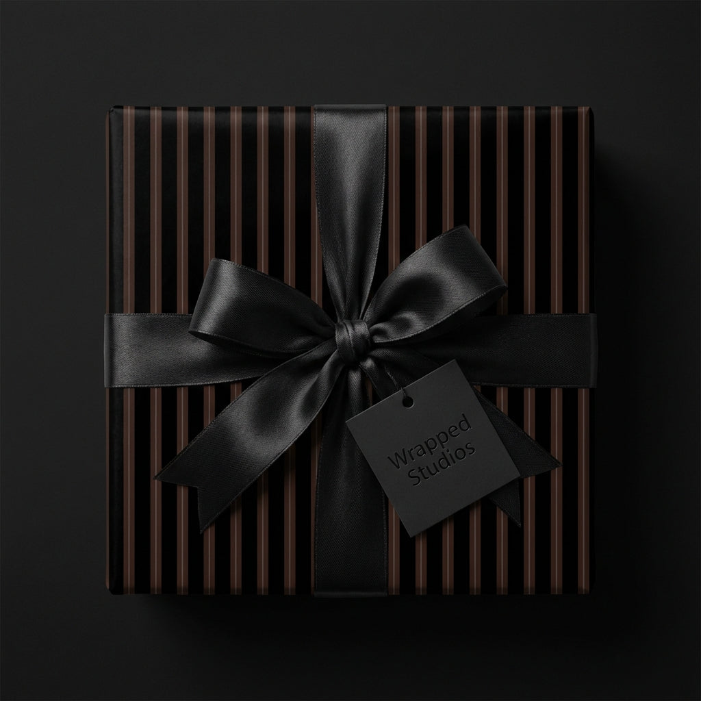 Elegant gift with black ribbon and striped modern wrapping paper for luxury gift-giving.
