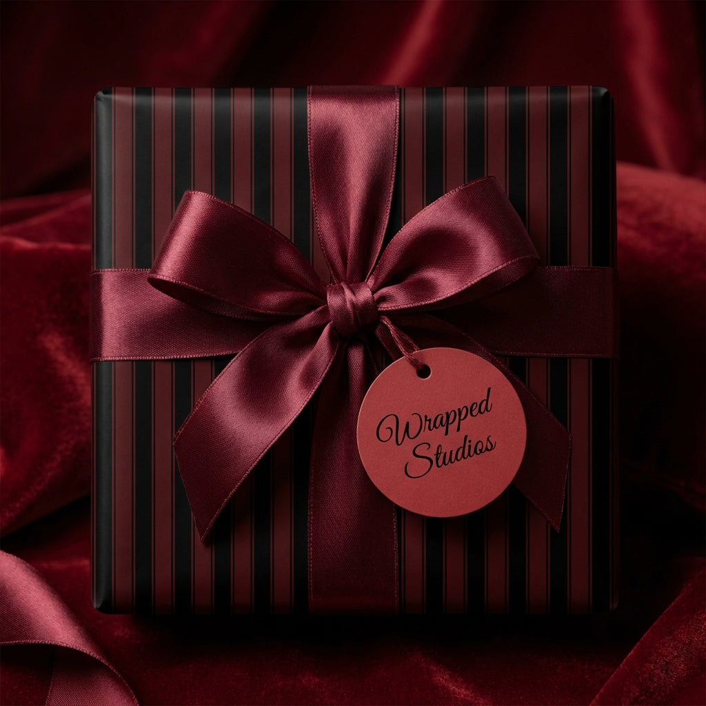 Elegant gift box with vertical striped wrapping paper and burgundy satin ribbon.