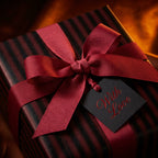 Elegant luxury gift wrap with striped black and red paper, crimson ribbon, and "With Love" tag.