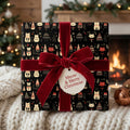 Black Christmas gift box wrapped in cat-themed wrapping paper with velvet ribbon and "Meow & Merry Christmas" tag.