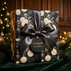 Luxury black and gold floral Christmas wrapping paper with a satin bow by Wrapped Studios.