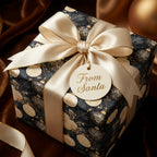 Elegant navy and gold Christmas wrapping paper with a champagne bow and From Santa tag by Wrapped Studios.