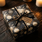 Luxury Christmas gift wrap with vintage gold ornaments and black velvet ribbon, by Wrapped Studios.
