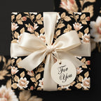 Vintage black floral wrapping paper with cream satin bow and 'For You' tag by Wrapped Studios.