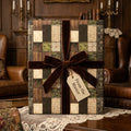 Luxury dark academia wrapping paper with a brown velvet bow by Wrapped Studios.
