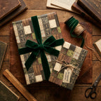 Rustic vintage gift wrap with green velvet ribbon on a wooden desk, by Wrapped Studios.