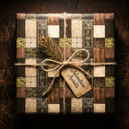 Medieval fantasy wrapping paper with a rustic twine bow and 'Adventure Awaits' tag by Wrapped Studios.