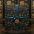 Elegant gift wrapped in luxury dragon wrapping paper, accented with a satin teal ribbon and ornate gift tag.