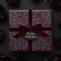 Elegant floral wrapping paper in deep burgundy and green, tied with a velvet ribbon and "For You, With Love" tag.