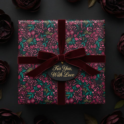 Elegant floral wrapping paper in deep burgundy and green, tied with a velvet ribbon and "For You, With Love" tag.