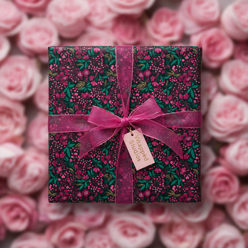 Elegant floral wrapping paper with a magenta ribbon on a square gift box, perfect for birthday or special occasion gifts.