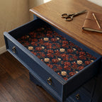 Vintage floral wrapping paper used as a drawer liner with red flowers on navy blue, by Wrapped Studios.