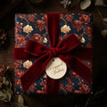 Luxury navy and red vintage floral wrapping paper with a burgundy velvet bow by Wrapped Studios.