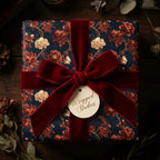 Luxury navy and red vintage floral wrapping paper with a burgundy velvet bow by Wrapped Studios.